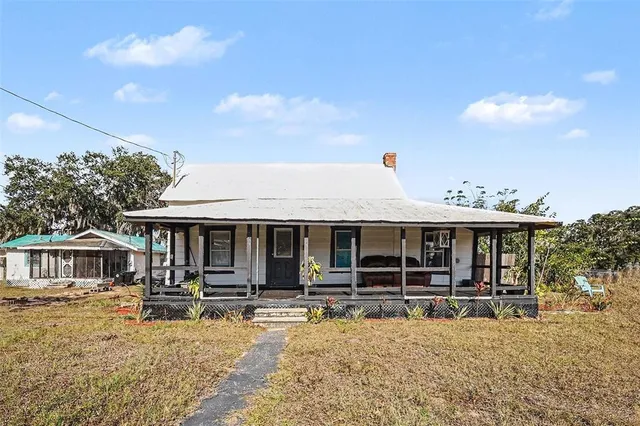 a view of a house with large windows and a table
