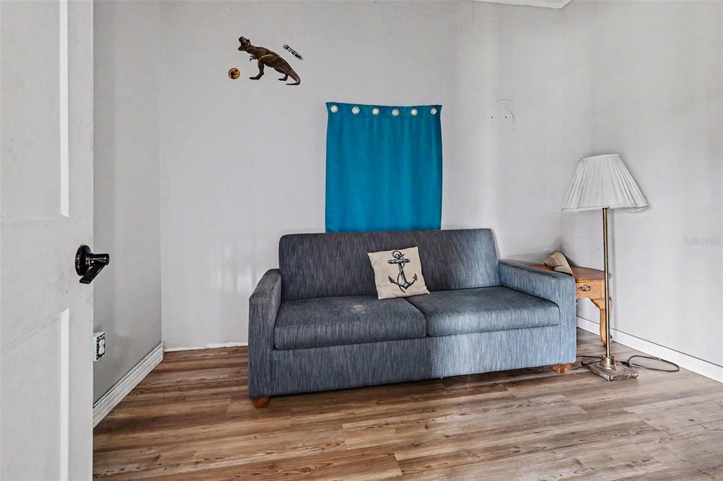 Undisclosed Address Frostproof, FL 33843 - Photo 4 of 22 a living room with furniture and a wooden floor