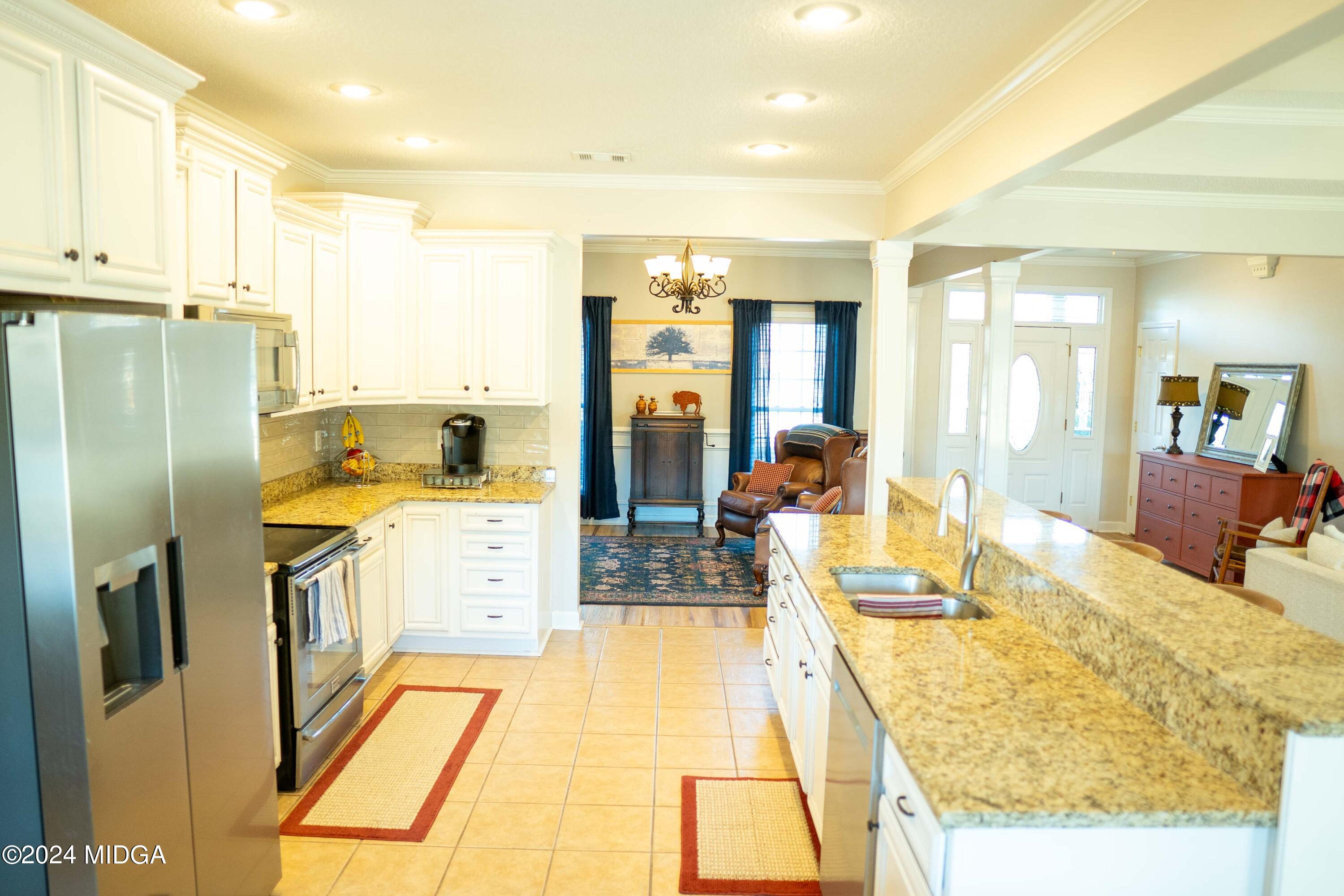 105 Windermere Circle Perry, GA 31069 - Photo 11 of 48 a large kitchen with kitchen island a large window