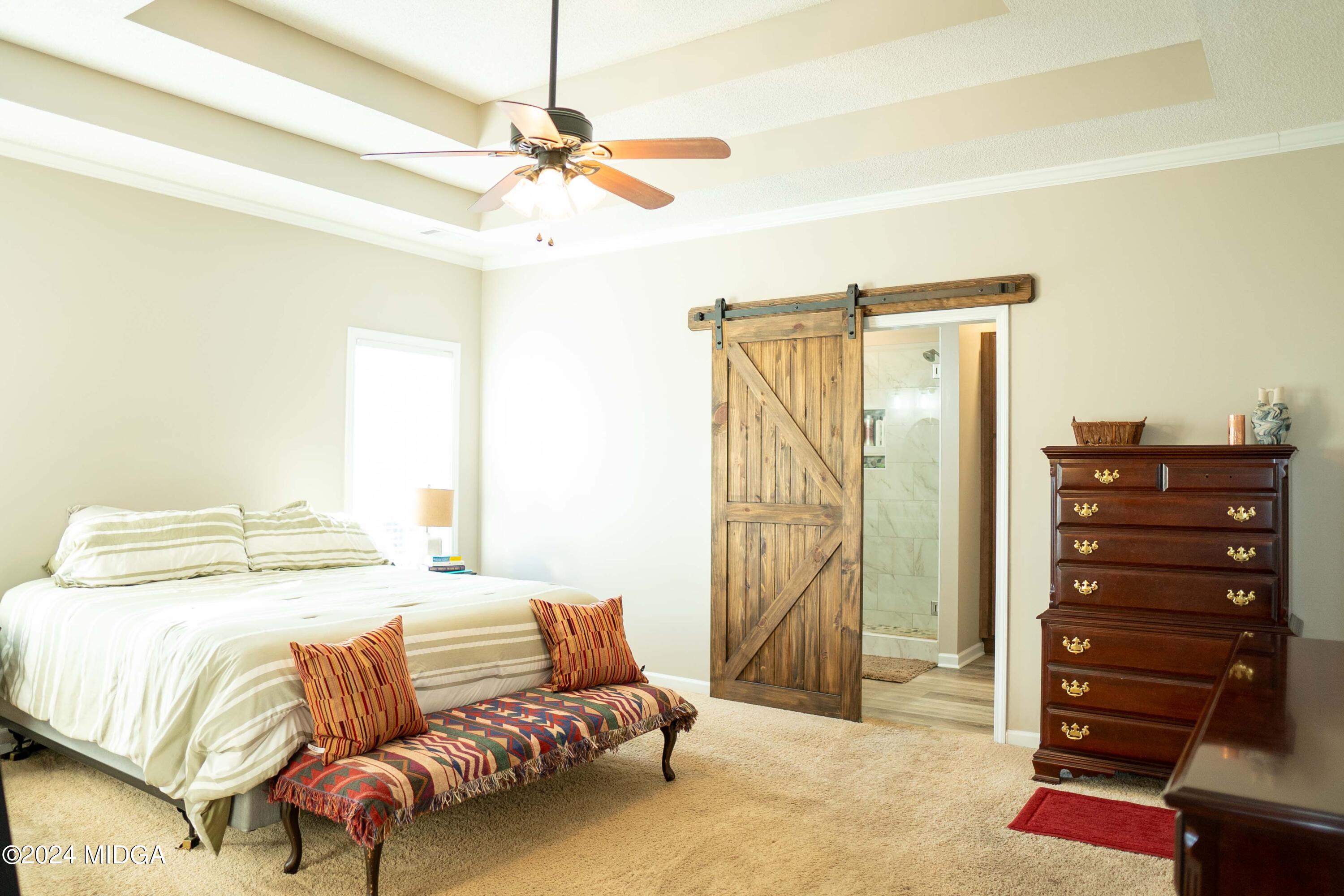 105 Windermere Circle Perry, GA 31069 - Photo 16 of 48 a bedroom with a bed and a walk in closet