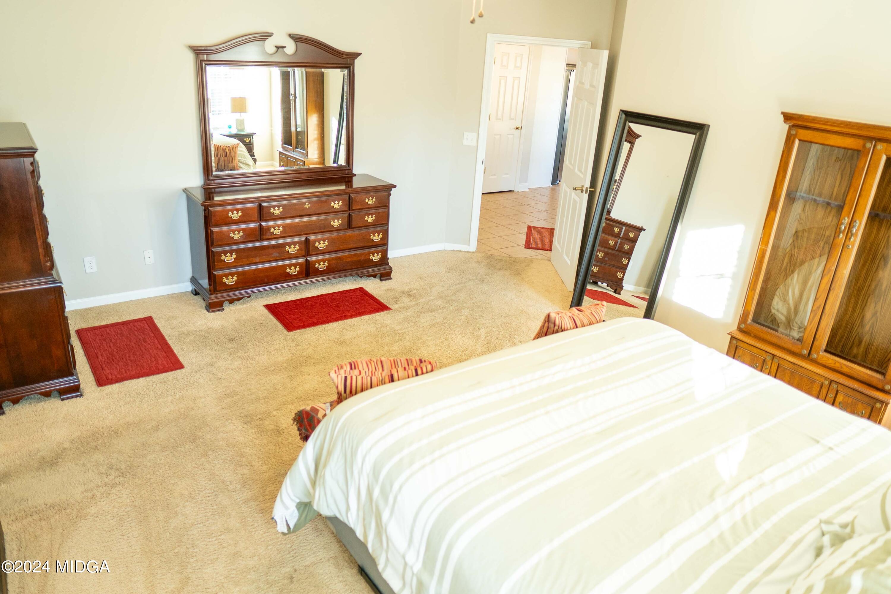 105 Windermere Circle Perry, GA 31069 - Photo 17 of 48 a bedroom with a bed and wooden floor