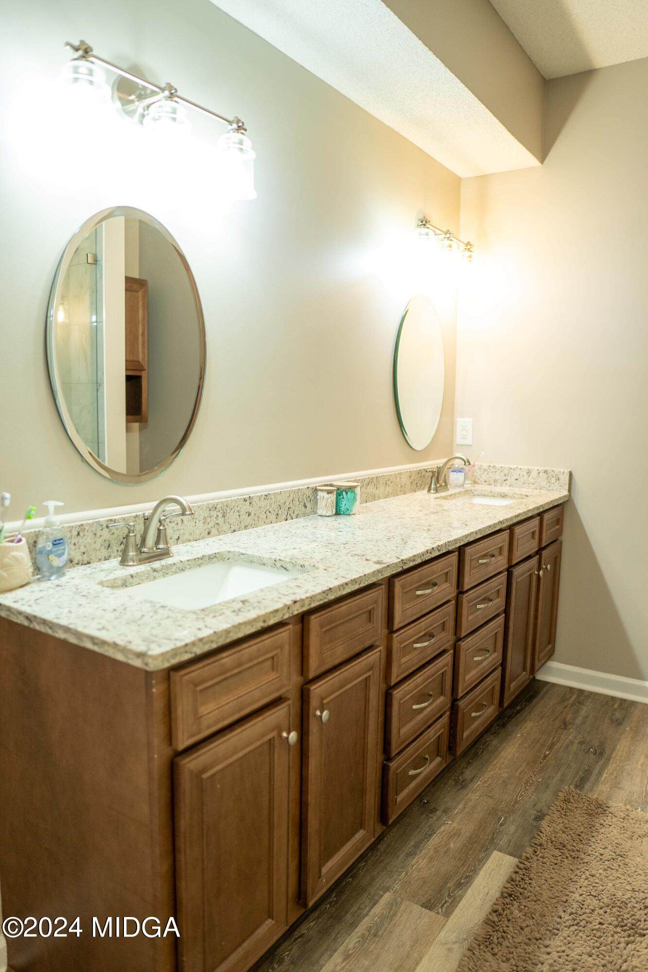 105 Windermere Circle Perry, GA 31069 - Photo 19 of 48 a bathroom with a granite countertop sink and a mirror