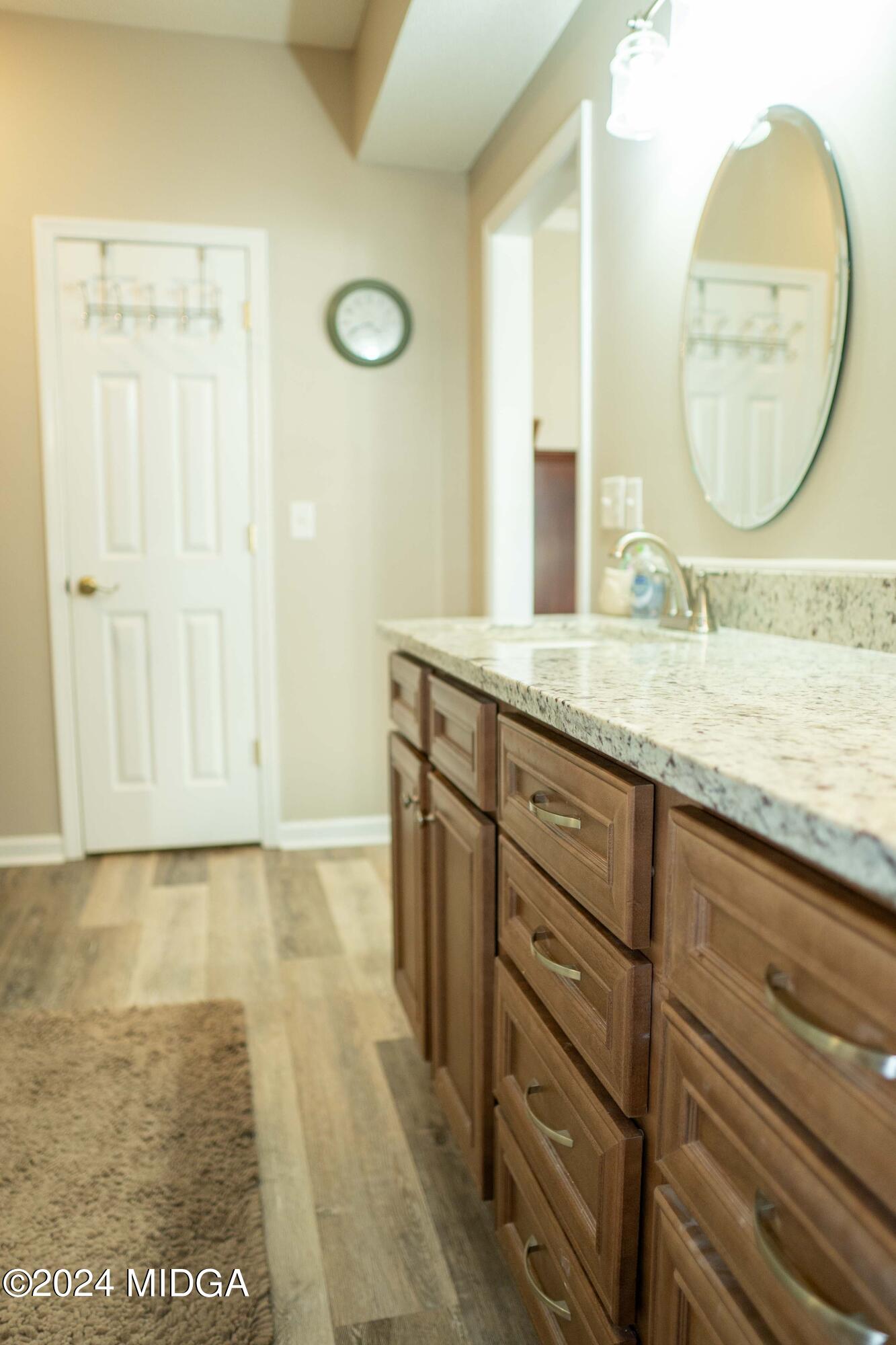 105 Windermere Circle Perry, GA 31069 - Photo 21 of 48 a bathroom with a granite countertop sink a mirror and a shower