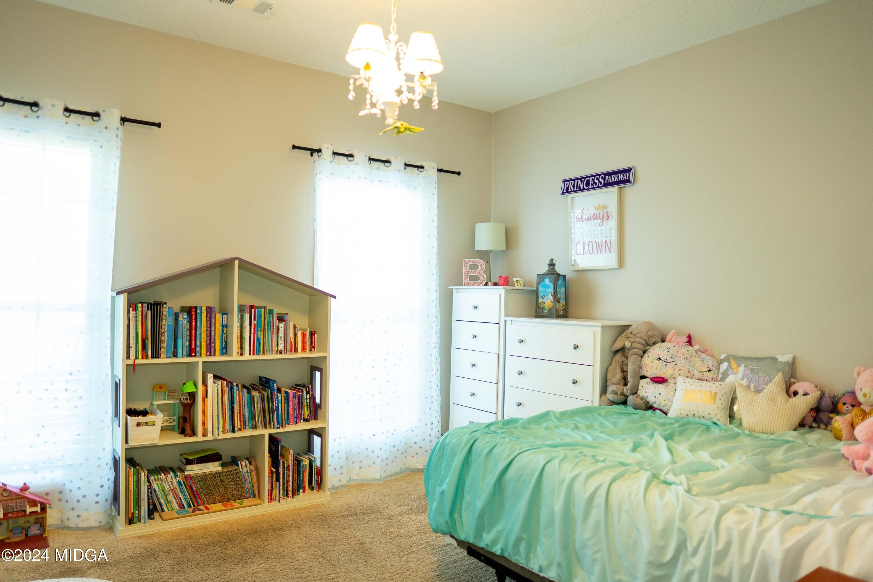 105 Windermere Circle Perry, GA 31069 - Photo 22 of 48 a bedroom with a bed and a book shelf