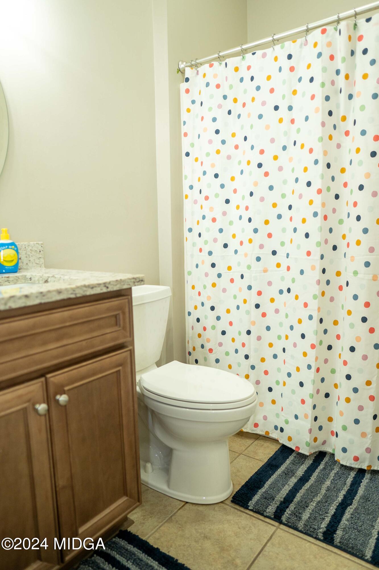 105 Windermere Circle Perry, GA 31069 - Photo 26 of 48 a bathroom with a toilet and a shower curtain