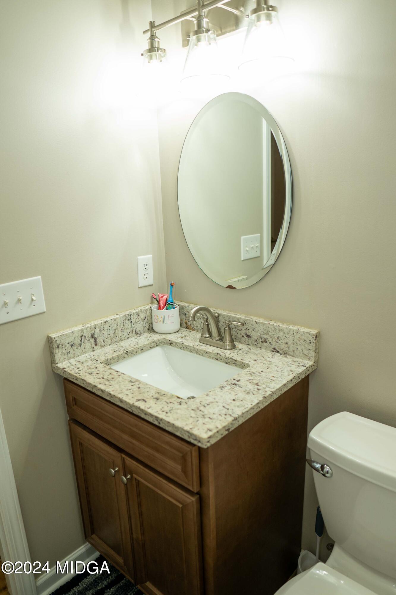 105 Windermere Circle Perry, GA 31069 - Photo 27 of 48 a bathroom with a granite countertop sink and a mirror