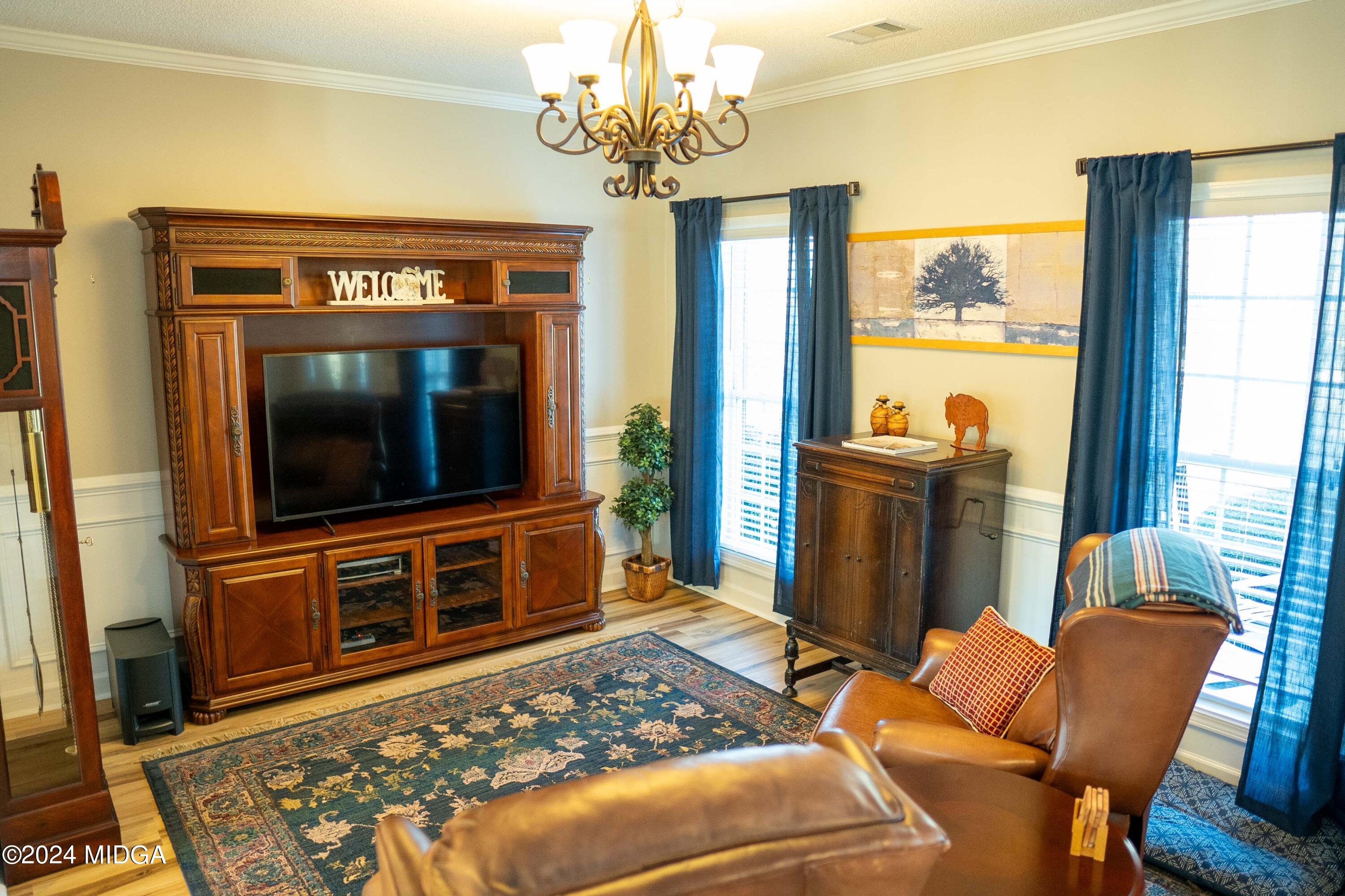105 Windermere Circle Perry, GA 31069 - Photo 8 of 48 a living room with furniture a flat screen tv and a fireplace