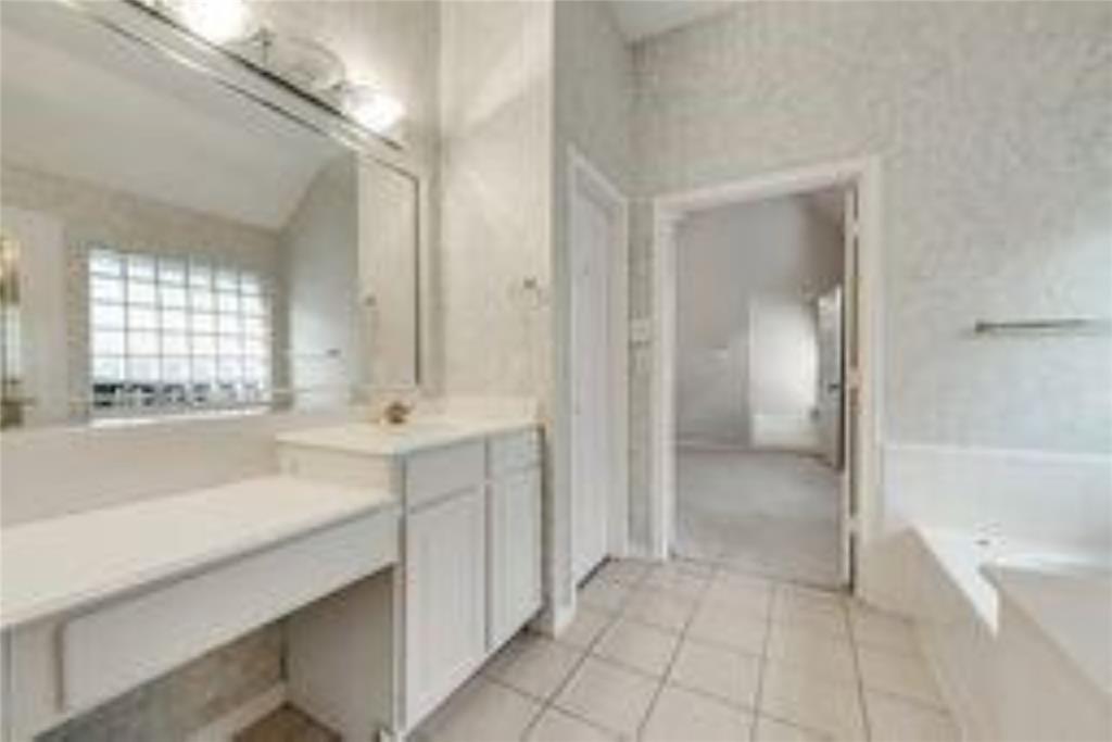 8417 Catskill Court Plano, TX 75025 - Photo 13 of 17 a spacious bathroom with a bathtub and a sink
