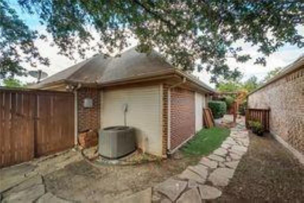 8417 Catskill Court Plano, TX 75025 - Photo 15 of 17 a view of a backyard with potted plants and a large tree