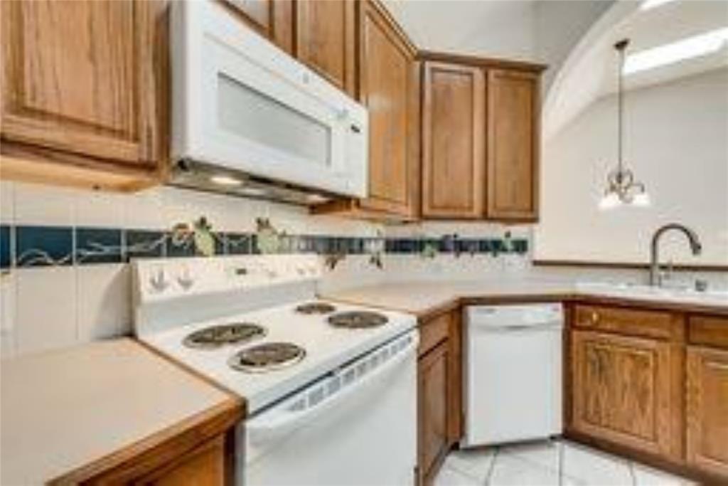 8417 Catskill Court Plano, TX 75025 - Photo 6 of 17 a kitchen with a sink a stove and cabinets