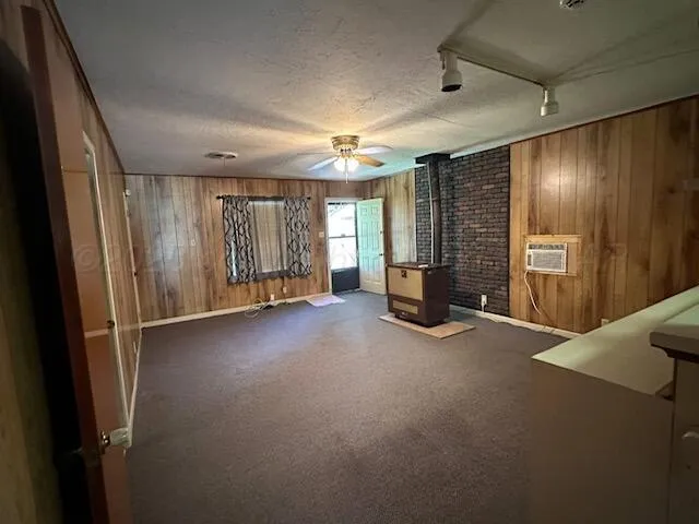 an empty room with fireplace and windows