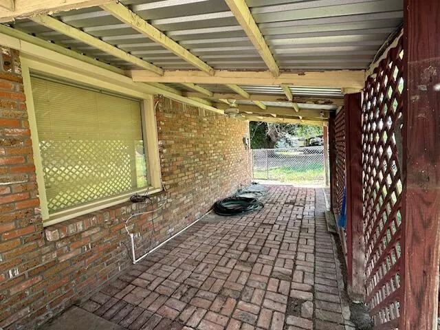 a view of a porch with a table and chairs