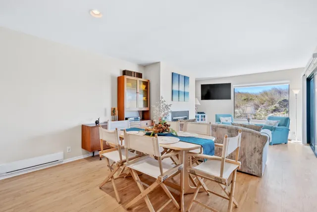 a view of a dining room with furniture and a flat screen tv