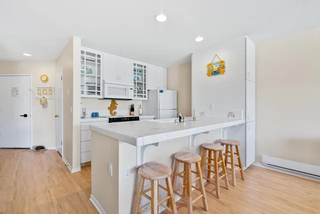 a kitchen with a sink cabinets and wooden floor