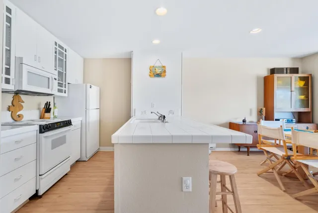 a kitchen with a sink and white cabinets