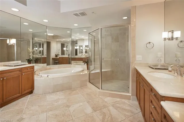 a spacious bathroom with a granite countertop sink a toilet a mirror and shower