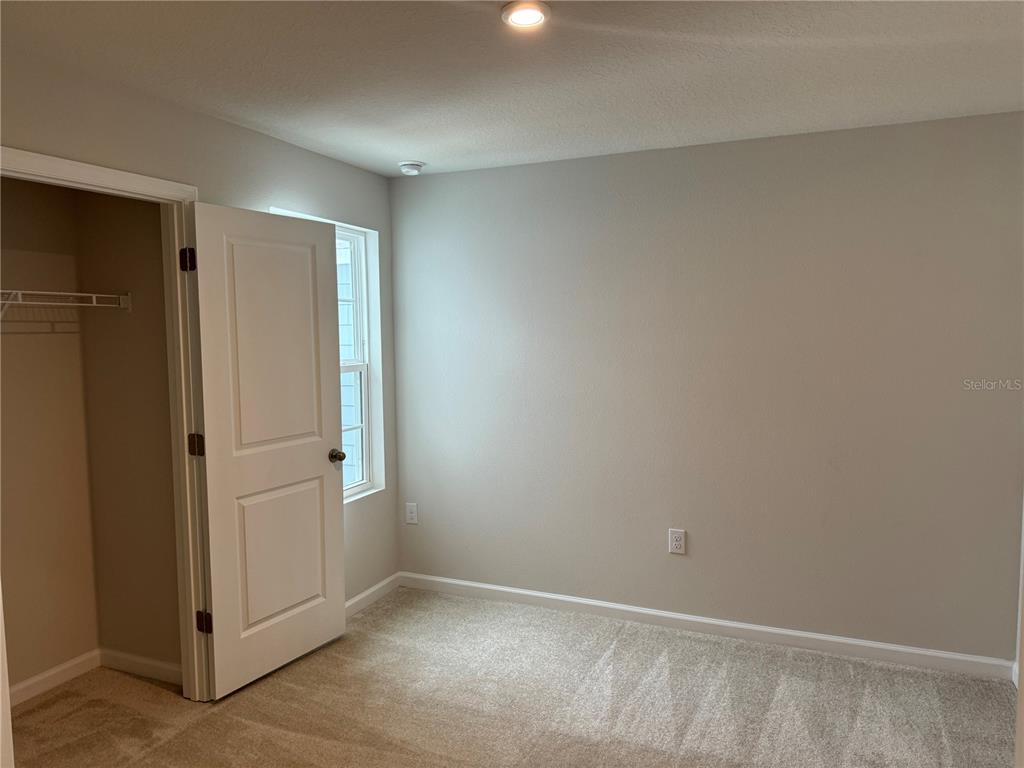 4612 Old Blush Street Lakewood Ranch, FL 34211 - Photo 12 of 19 an empty room with closet area