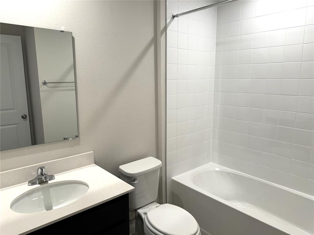 4612 Old Blush Street Lakewood Ranch, FL 34211 - Photo 14 of 19 a bathroom with a sink toilet and shower