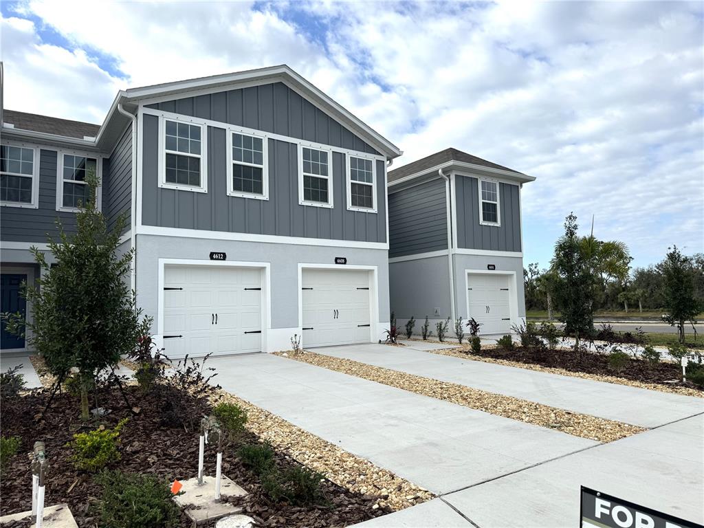 4612 Old Blush Street Lakewood Ranch, FL 34211 - Photo 2 of 19 a front view of a house with a yard