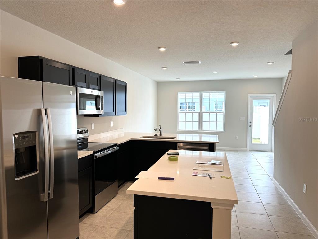 4612 Old Blush Street Lakewood Ranch, FL 34211 - Photo 3 of 19 a kitchen with a sink a stove and refrigerator