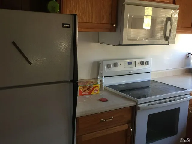 a kitchen with a stove and a refrigerator