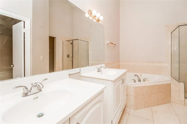 a bathroom with a tub sink and mirror