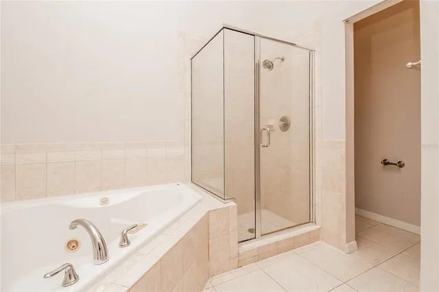 a bathroom with a tub and shower