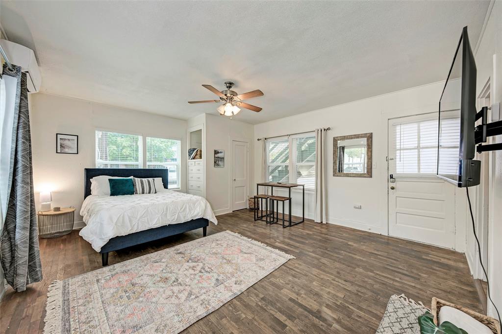 915 West 21st Street, Unit 2 Austin, TX 78705 - Photo 3 of 9 a bedroom with a large bed and a chandelier