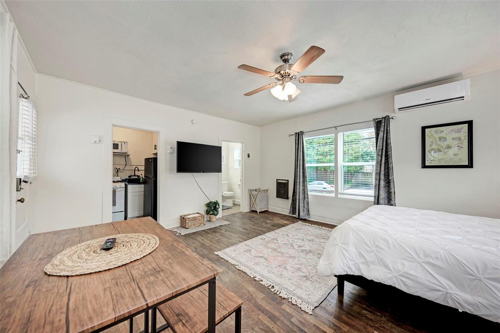 915 West 21st Street, Unit 2 Austin, TX 78705 - Photo 4 of 9 a bed room with a bed a television and a window