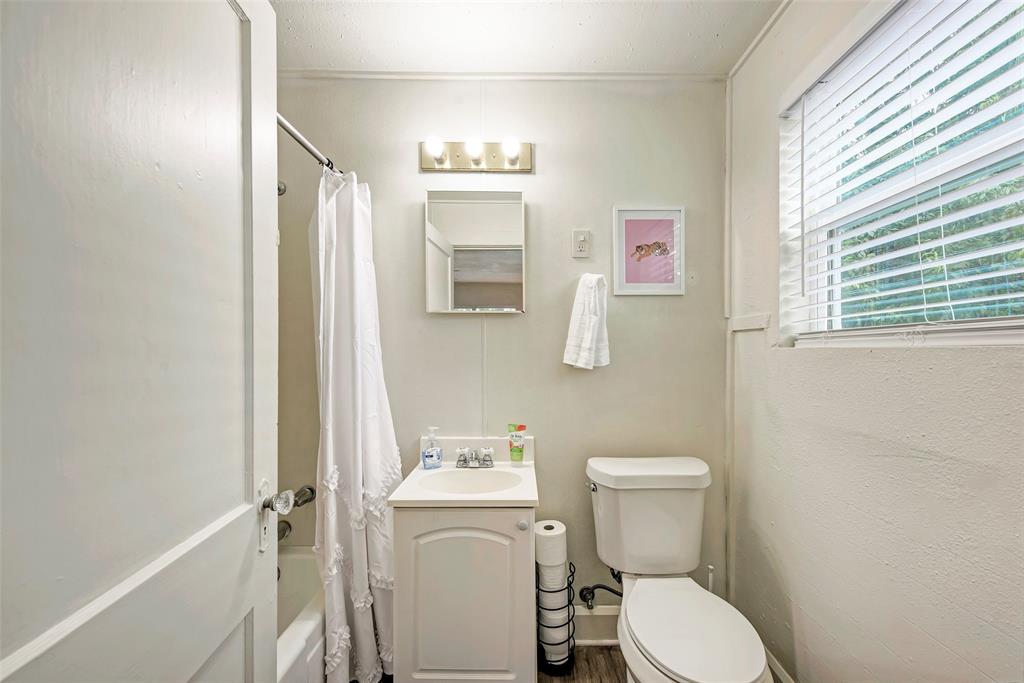 915 West 21st Street, Unit 2 Austin, TX 78705 - Photo 5 of 9 a white toilet sitting next to a bathroom sink and vanity