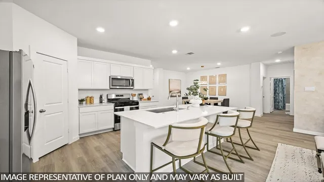 a kitchen with stainless steel appliances a refrigerator stove microwave and cabinets