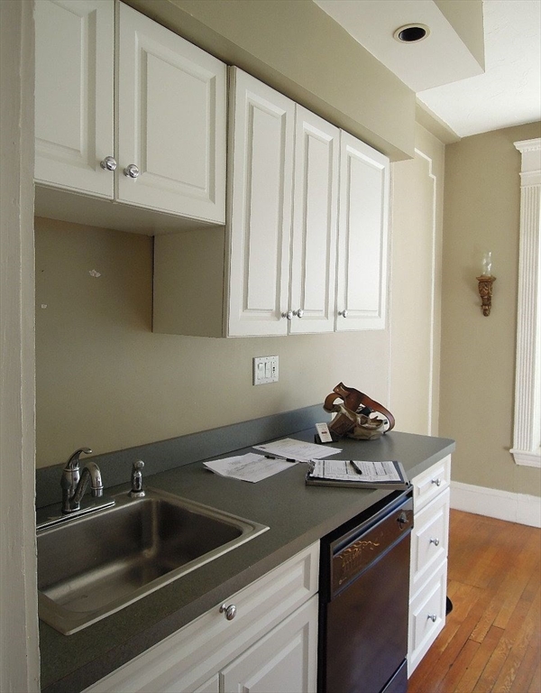 8 Garrison Street, Unit 209 Boston, MA 02116 - Photo 26 of 33 a kitchen with granite countertop a sink dishwasher stove and cabinets