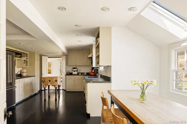 a kitchen with lots of counter top space and dining table