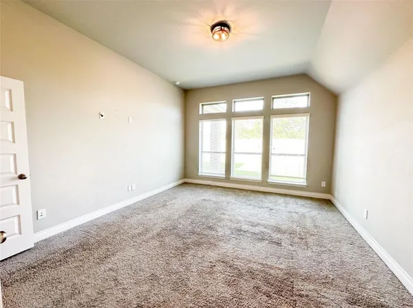 an empty room with a empty space and windows