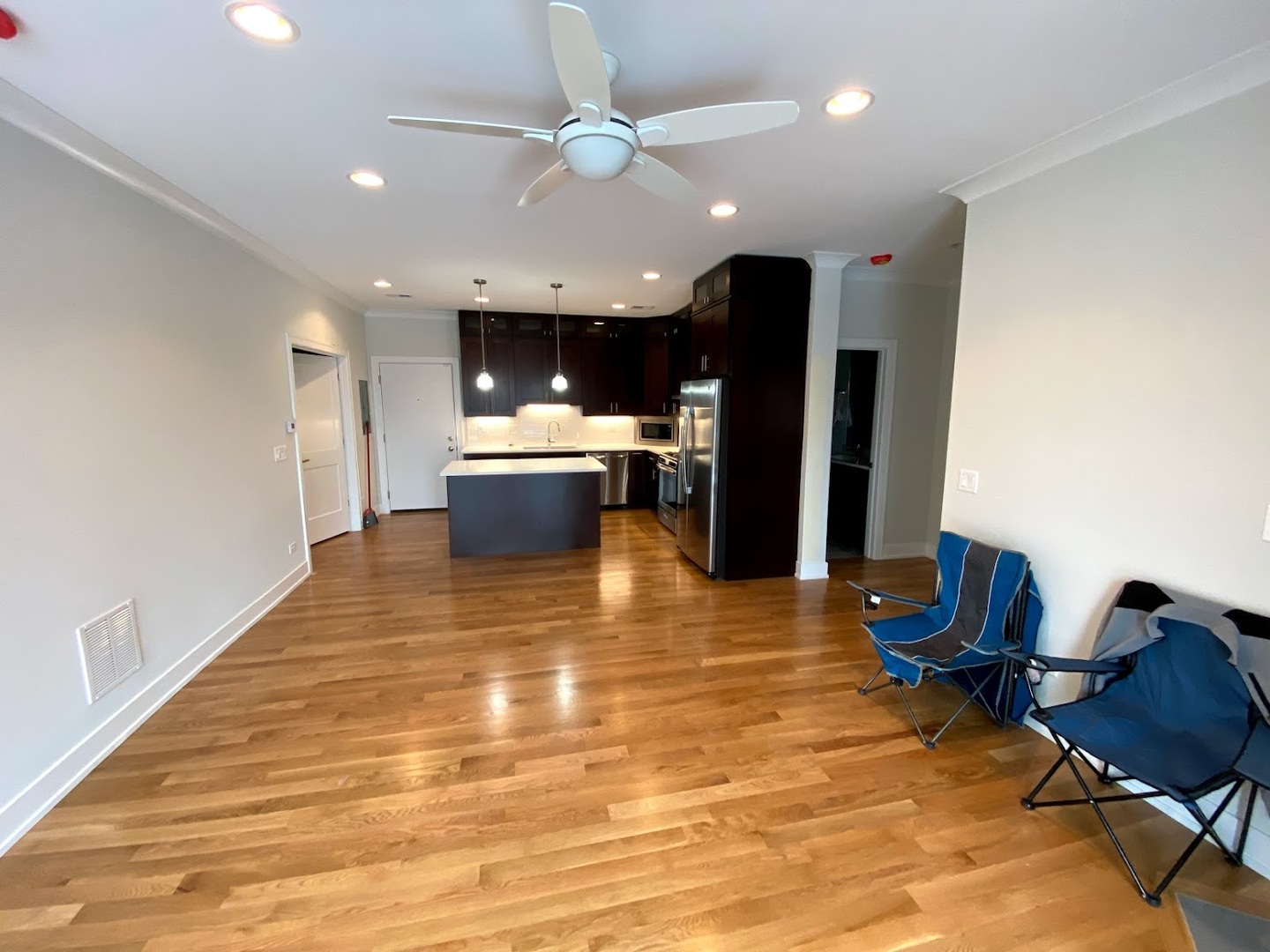 3203 North Ridgeway Avenue, Unit 2B Chicago, IL 60618 - Photo 3 of 17 a view of kitchen and dining room with furniture a chandelier fan and wooden floor