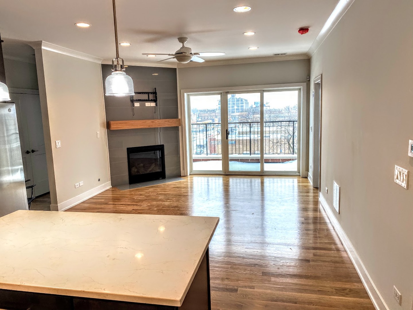 3203 North Ridgeway Avenue, Unit 2B Chicago, IL 60618 - Photo 6 of 17 a view of a livingroom with a fireplace wooden floor and chandelier
