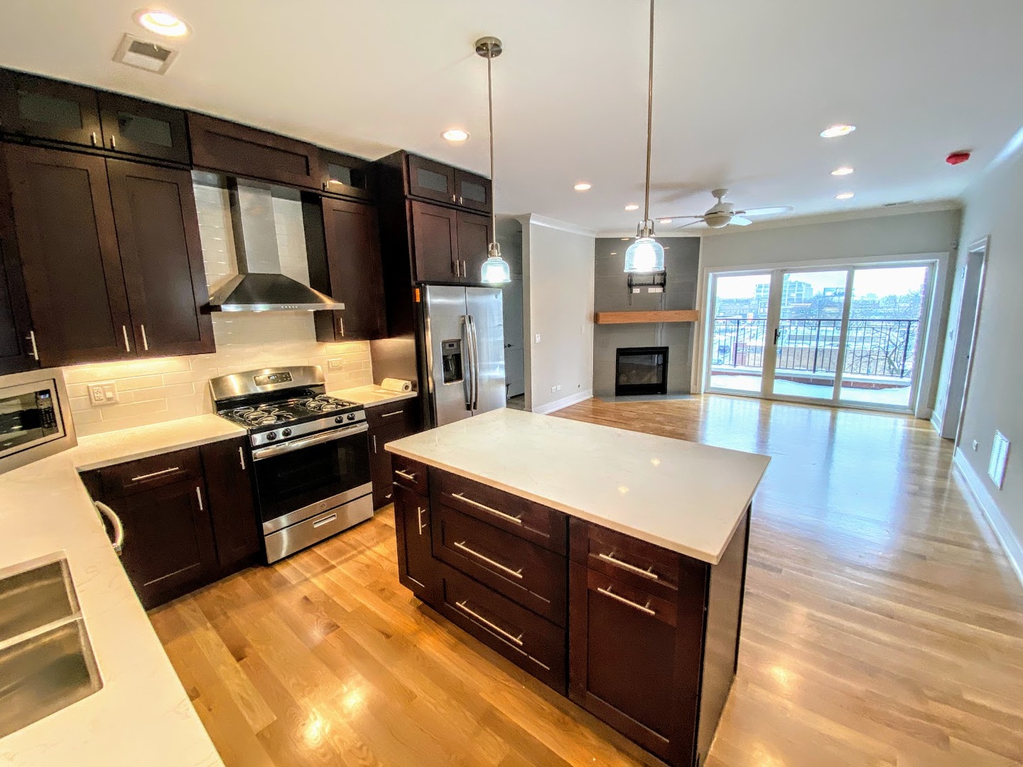 3203 North Ridgeway Avenue, Unit 2B Chicago, IL 60618 - Photo 7 of 17 a kitchen with stainless steel appliances granite countertop a stove a refrigerator a sink and a wooden cabinets
