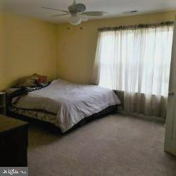 8405 Tee Road Lusby, MD 20657 - Photo 13 of 19 a bedroom with a bed and a window