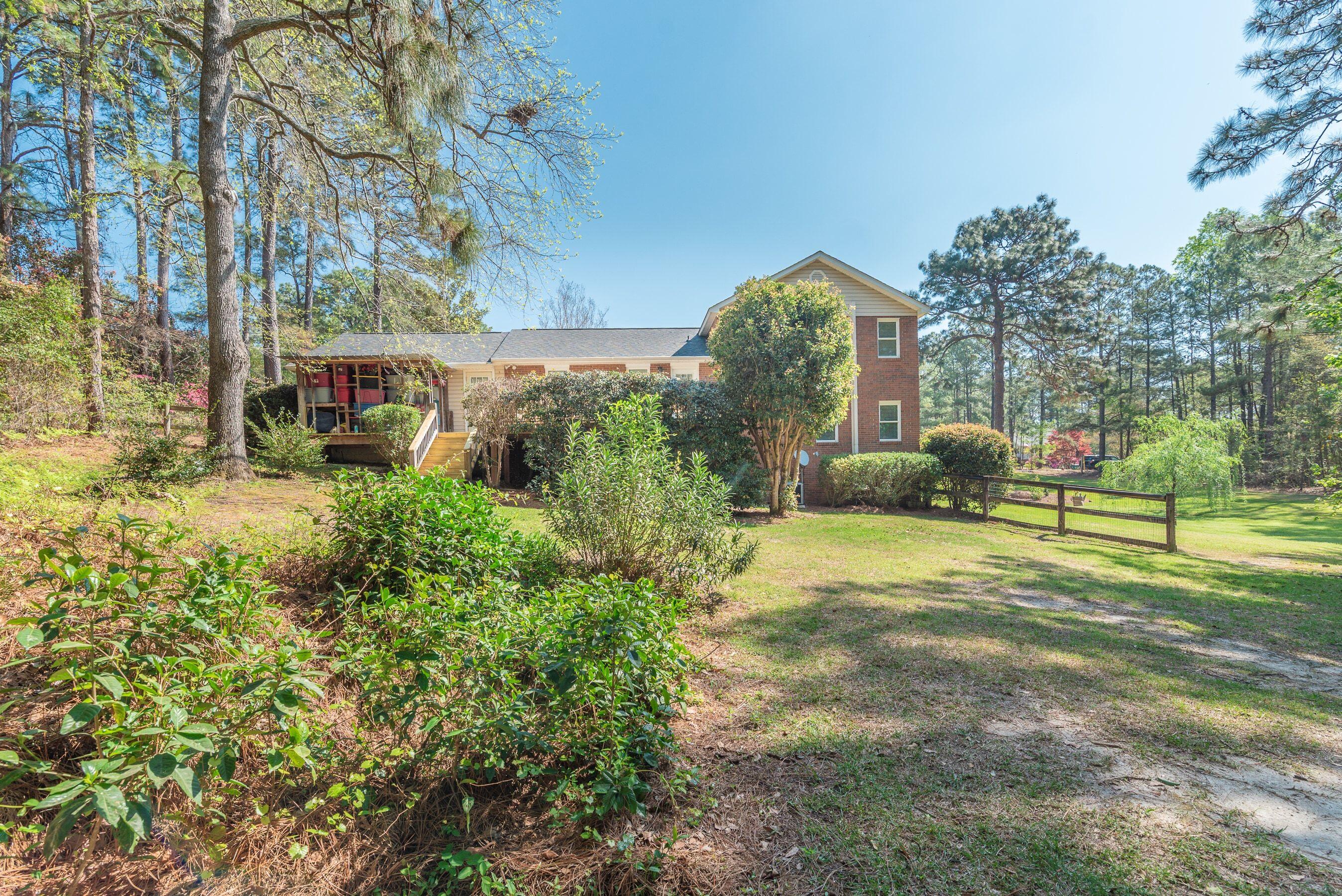 1117 Ridgemont Drive Aiken, SC 29803 - Photo 38 of 49 a backyard of a house with lots of green space and fountain
