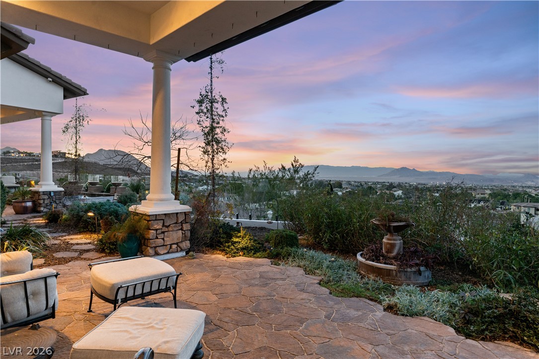 1123 Christian Road Henderson, NV 89002 - Photo 75 of 94 An inviting stone patio unfolds to a breathtaking vista of mountains and city lights.