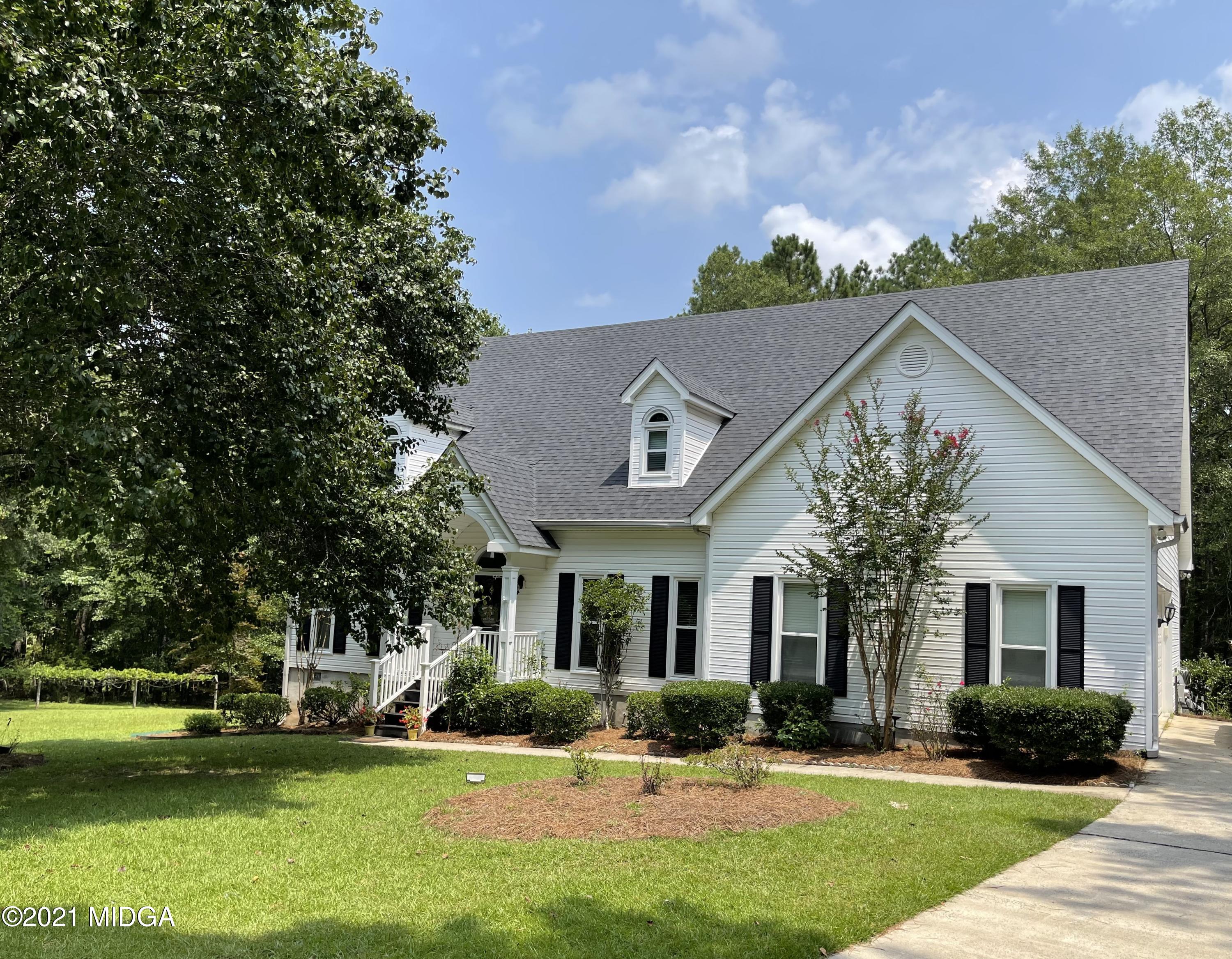 253 Ridge Crest Drive Macon, GA 31210 - Photo 1 of 16 a front view of a house with a yard and potted plants
