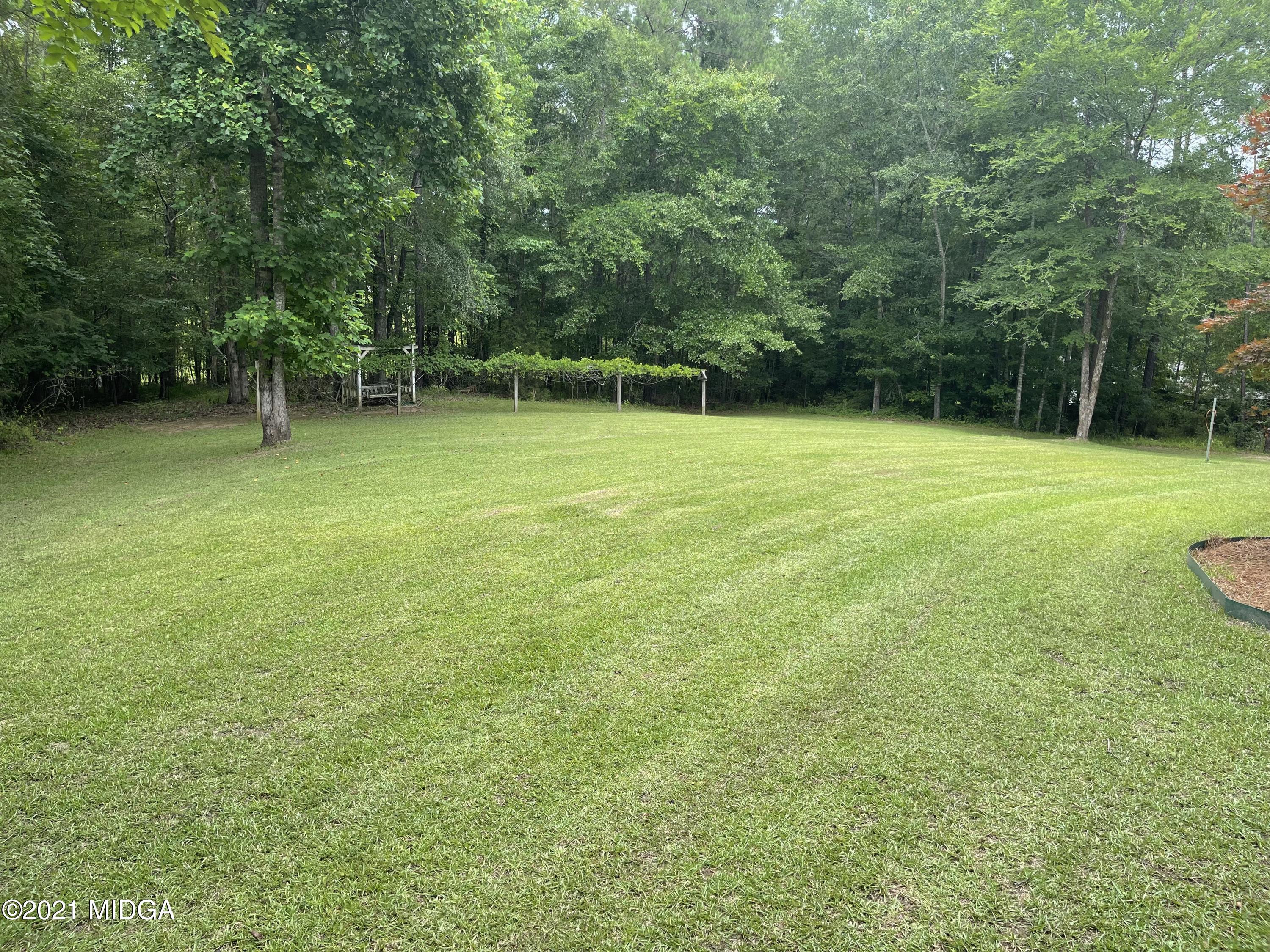 253 Ridge Crest Drive Macon, GA 31210 - Photo 16 of 16 a view of a field with a trees in the background