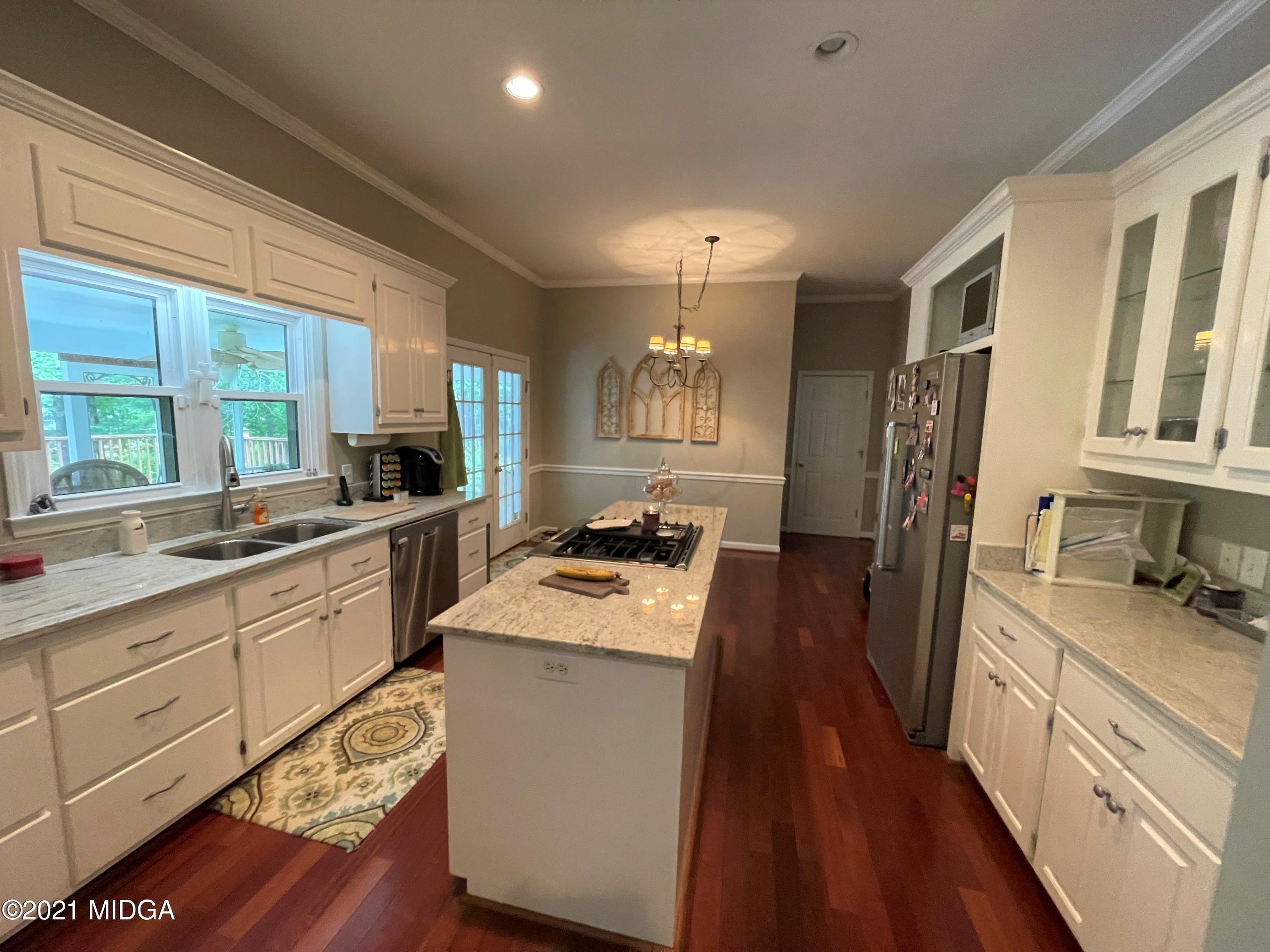 253 Ridge Crest Drive Macon, GA 31210 - Photo 5 of 16 a kitchen with a stove a sink a refrigerator and cabinets