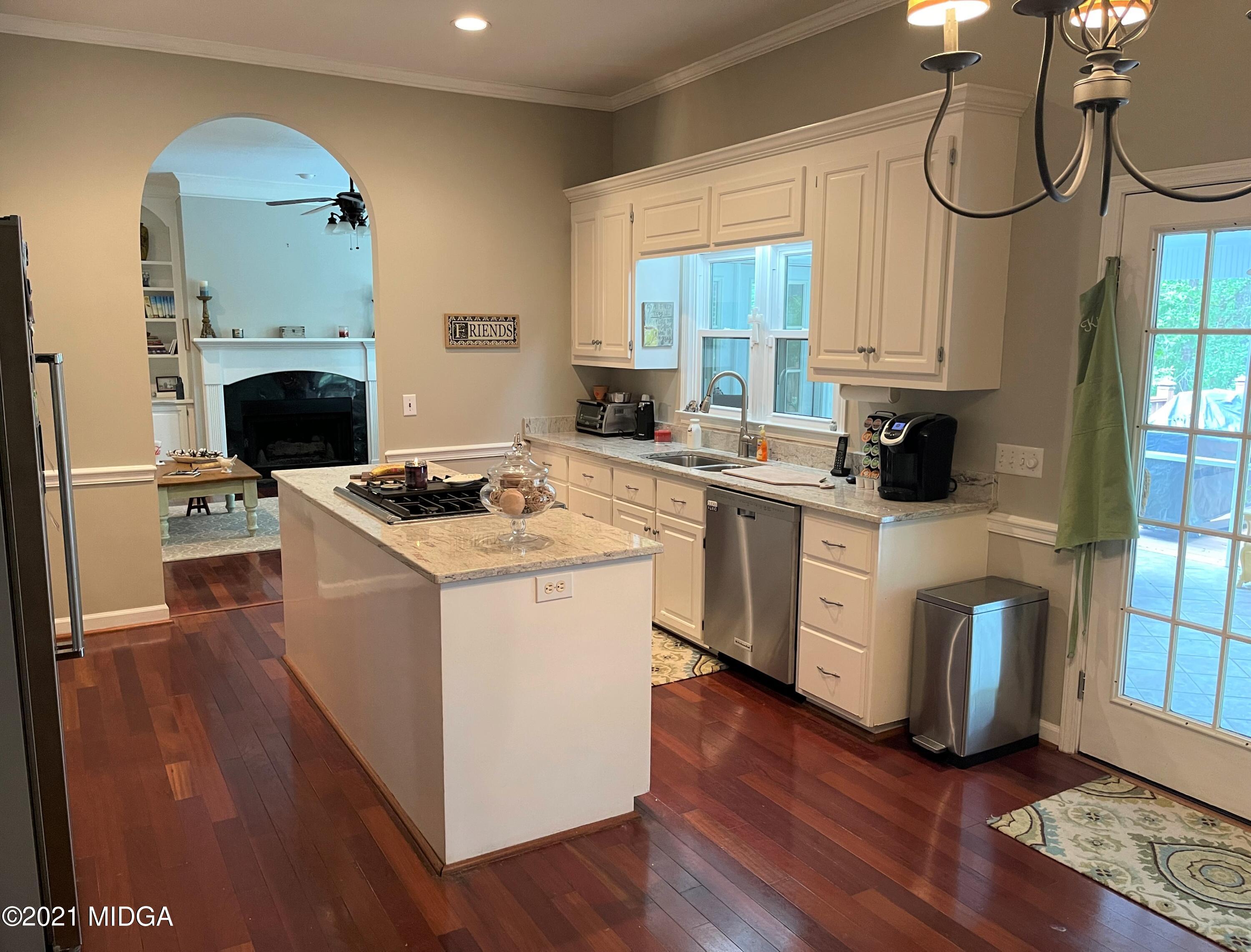 253 Ridge Crest Drive Macon, GA 31210 - Photo 6 of 16 a kitchen with a stove a sink and a refrigerator