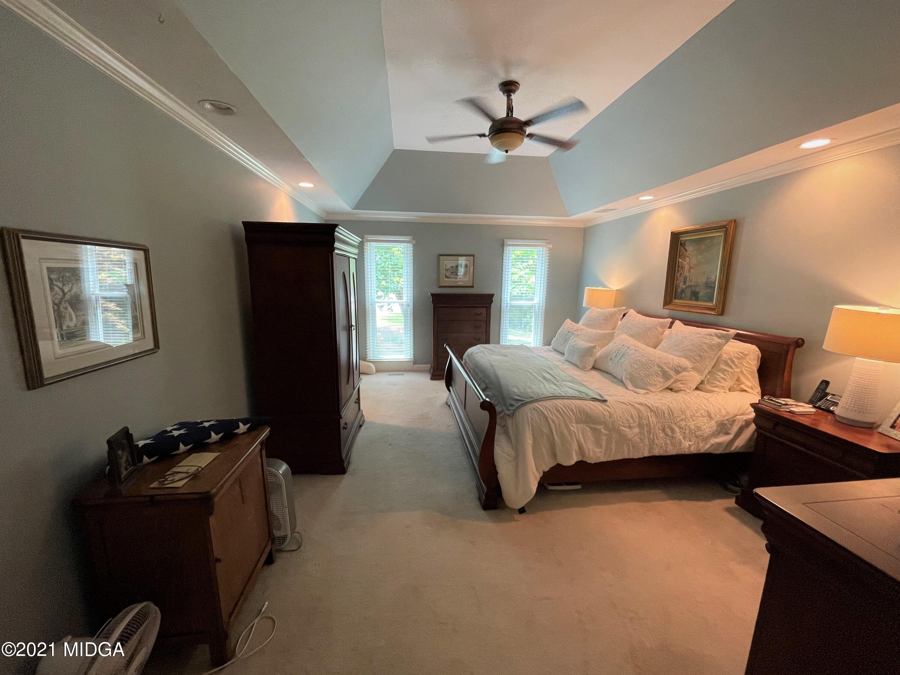 253 Ridge Crest Drive Macon, GA 31210 - Photo 8 of 16 a spacious bedroom with a bed and a chandelier