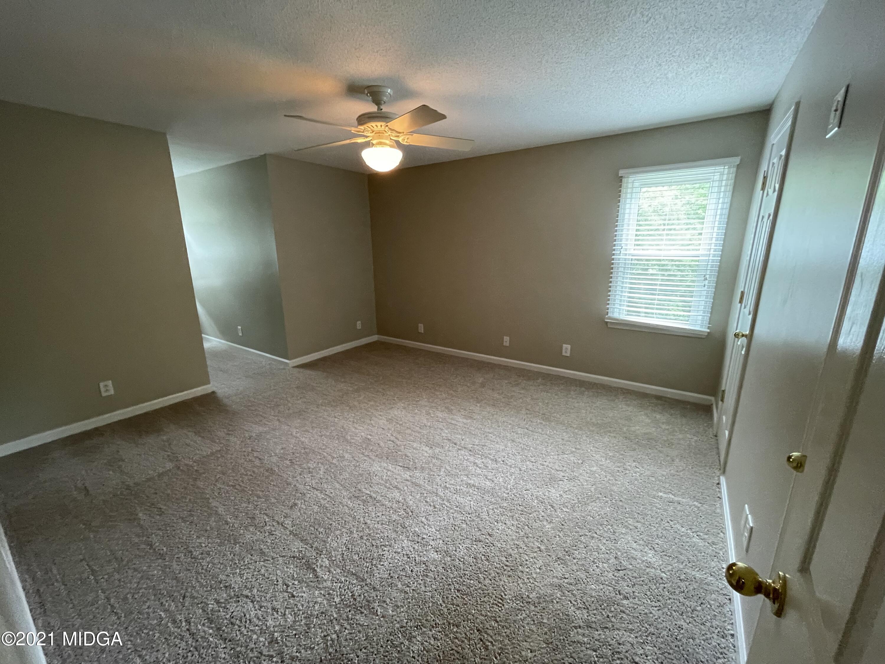 253 Ridge Crest Drive Macon, GA 31210 - Photo 9 of 16 an empty room with windows and fan