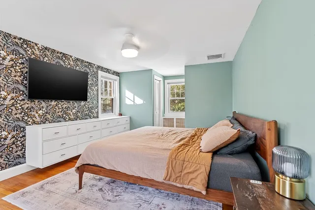 a bedroom with a bed and a flat screen tv