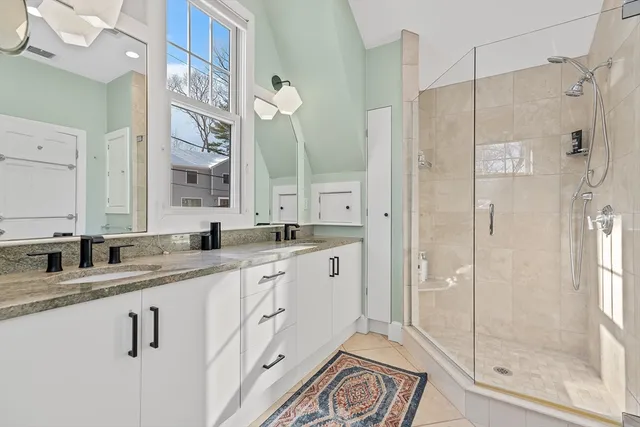 a bathroom with a granite countertop sink mirror and double