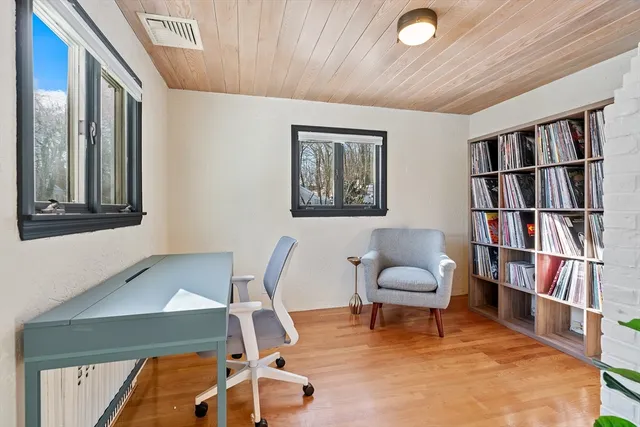 a living room with furniture and a book shelf