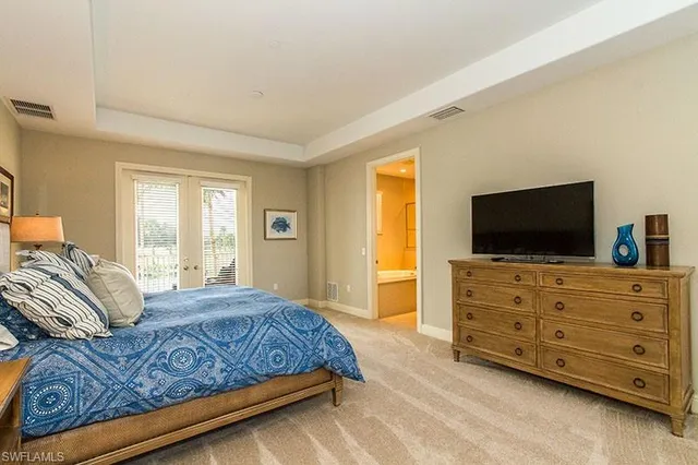 a bedroom with a bed and flat screen tv